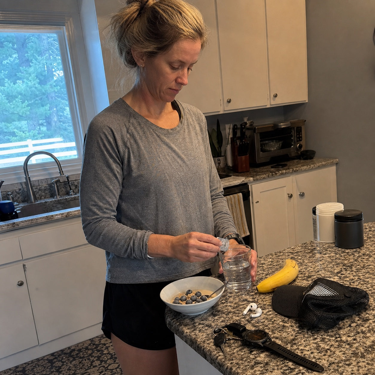 Recreational runner preparing a simple early-morning routine in her kitchen