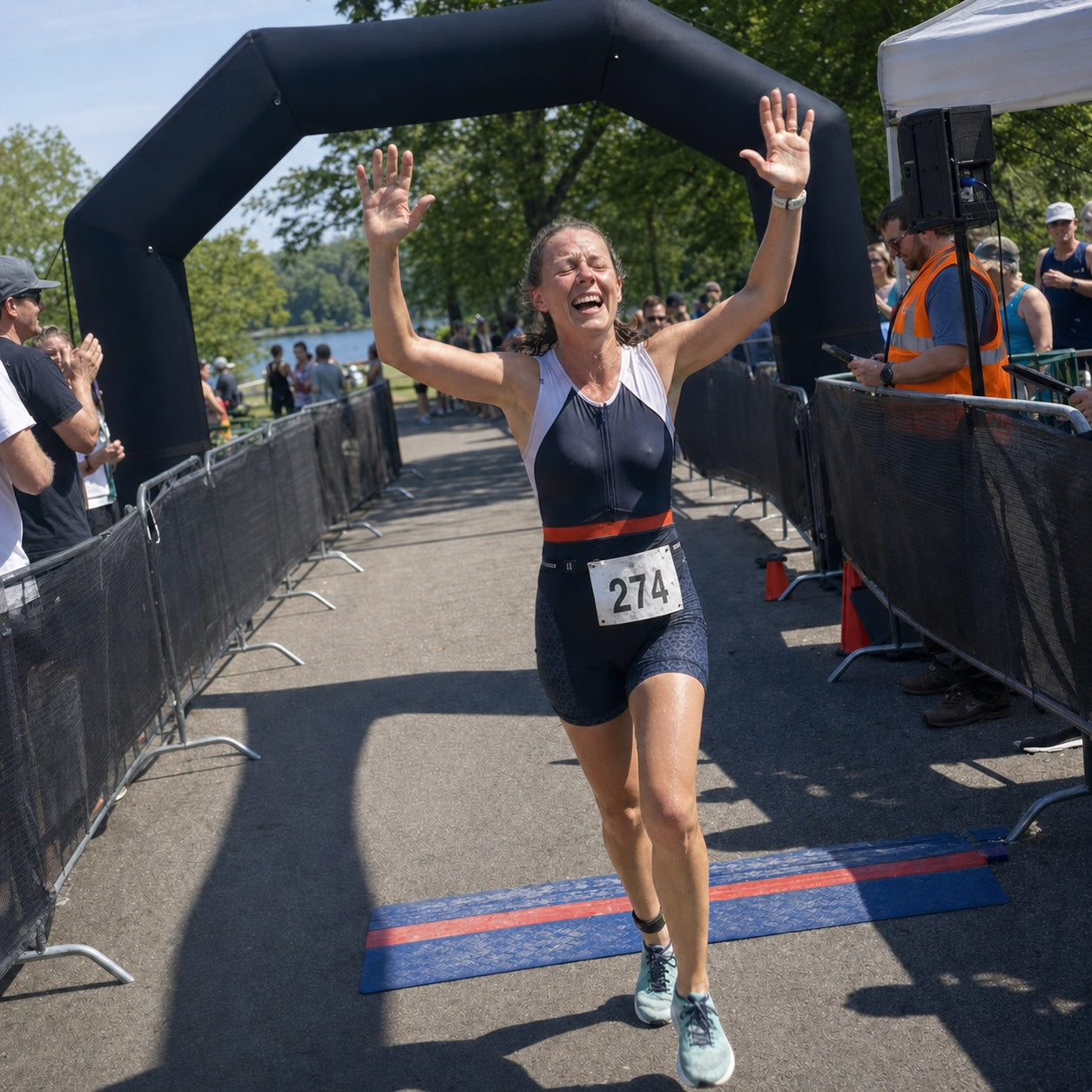 An amateur triathlete crossing a local race finish line